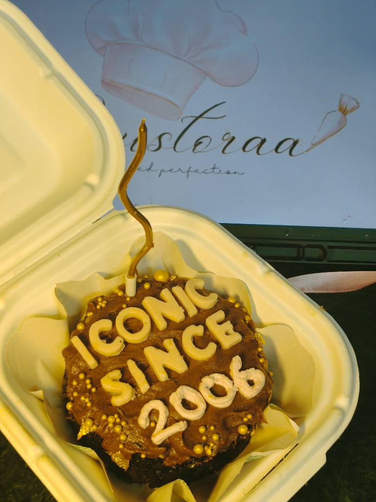 Crustora handcrafted signature bento cake with golden candle and custom lettering